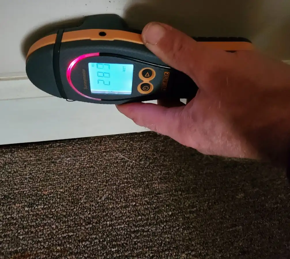Moisture detection at baseboard during Storm Damage Restoration in Burleson